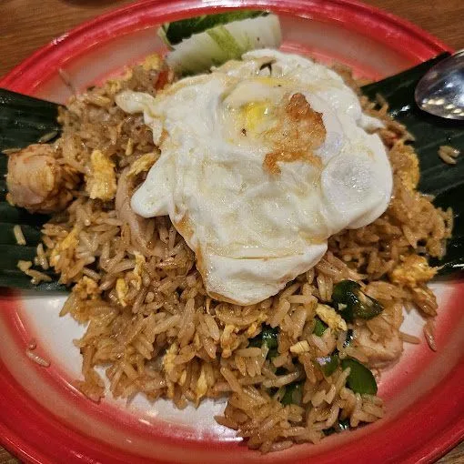 Tom yum fried rice with seafood and a fried egg