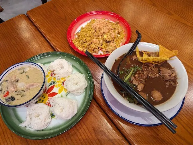 Spread of ChilChil Thai dishes on a wooden table